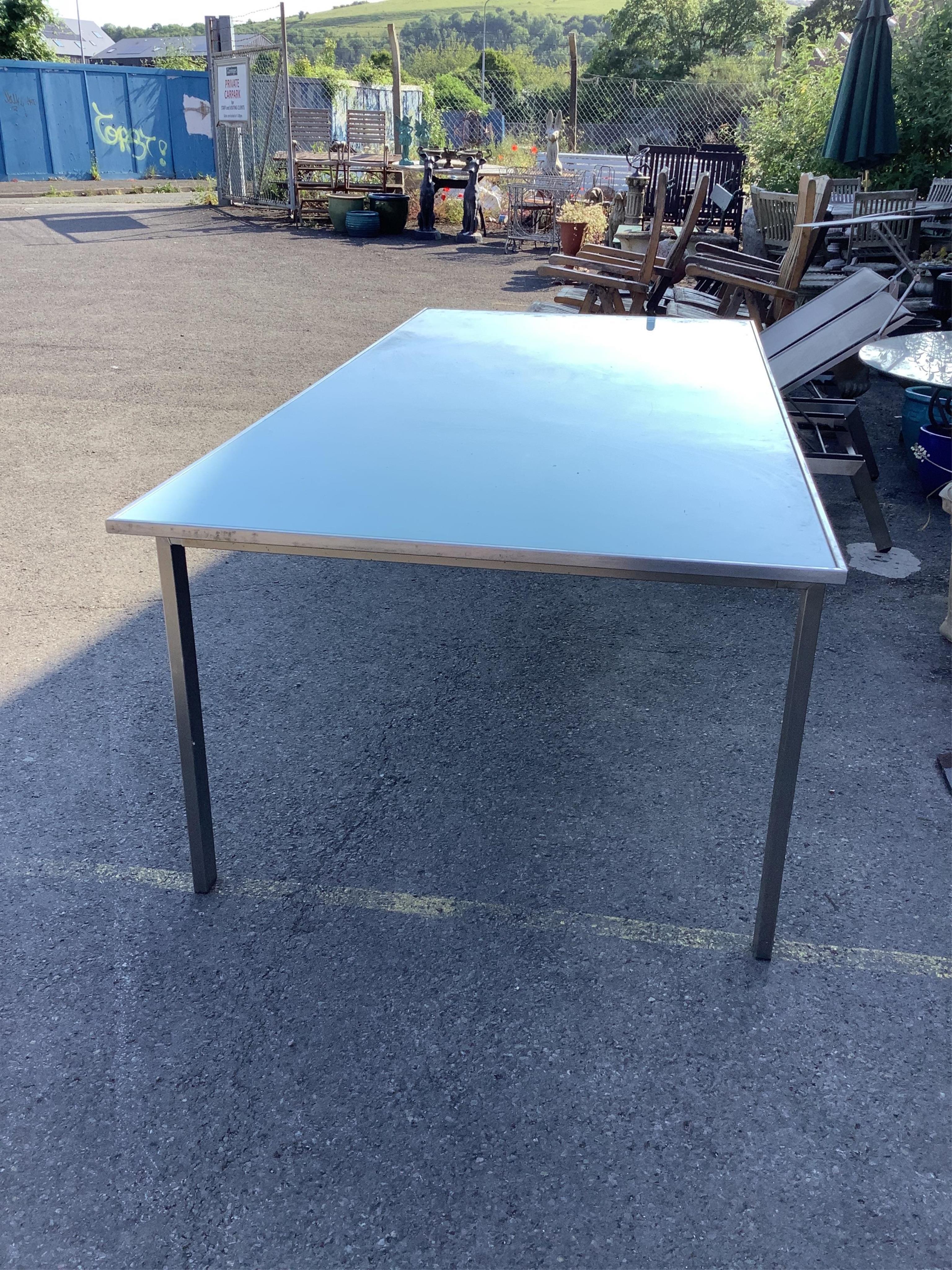 A Barlow Tyrie Mercury stainless steel (marine grade) glass top garden table, width 220cm, depth 101cm, height 74cm. Condition - fair